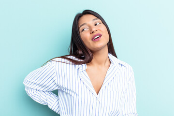 Young Venezuelan woman isolated on blue background suffering a back pain.