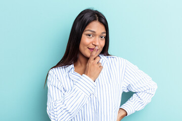 Fototapeta premium Young Venezuelan woman isolated on blue background thinking and looking up, being reflective, contemplating, having a fantasy.