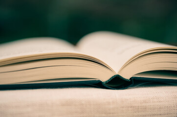 open book, binding in focus, pages in soft focus. concept education,