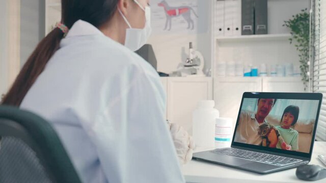 Asian veterinarian girl talk to pet owner on online virtual video call
