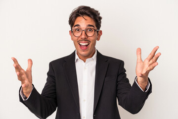 Young mixed race business man isolated on white background receiving a pleasant surprise, excited and raising hands.