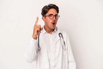 Young mixed race doctor man isolated on white background having an idea, inspiration concept.