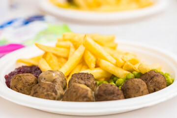 Traditional meatballs with fried potatoes, herbs and cranberry sauce. 
