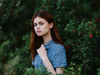woman in dress walking green leaves nature fresh air