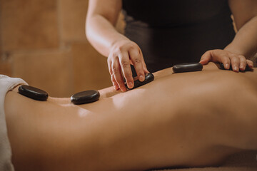 Massage with hot basalt stones. Beautiful deep charming light.