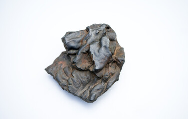 An ancient fragment of brown iron ore on a white isolate.Mining operations.