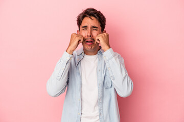 Young mixed race man isolated on white background whining and crying disconsolately.