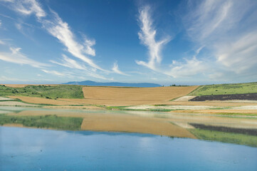 Fototapeta premium Cereal field on the shore the raft of Zolina , a saline redoubt of an ancient sea in the Pyrenees, Navarra, Spain