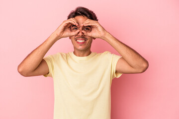 Fototapeta premium Young mixed race man isolated on white background showing okay sign over eyes
