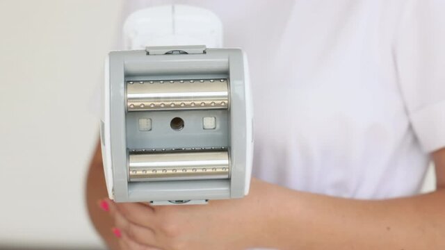 The handle of the massage device. body massage. beauty salon. the maniple. Manipulator for lpg massage on the hands of a cosmetologist. Close-up view.