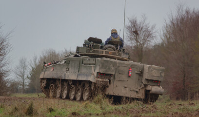 Fototapeta premium British army Warrior FV510 light infantry fighting vehicle tank in action on a military exercise, Salisbury Plain, Wiltshire UK