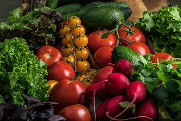 Yellow cherry tomatoes and other vegetables. Vegetarian still life. Fresh vegetables. Natural background.