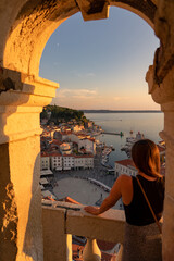 blurred tourist woman watching the beautiful sunset in Piran Zvonik Campanile Bell Tower