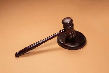 Gavel down on stand on brown background. Justice of law system conceptual.