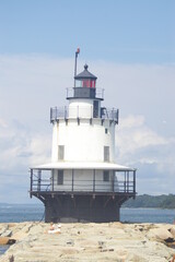 white lighthouse on beach in Maine