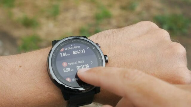Results of a running training session on smart watch. Smartwatch. Hand with sports watch which shows results of training. Pulse, speed, distance, calories
