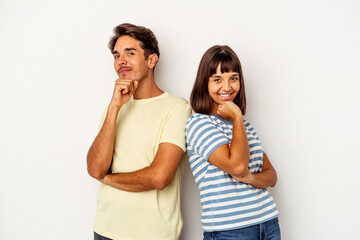 Young mixed race couple isolated on white background smiling happy and confident, touching chin with hand.