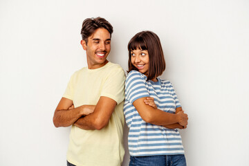 Young mixed race couple isolated on white background laughing and having fun.