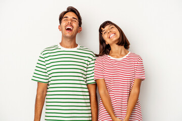 Fototapeta premium Young mixed race couple isolated on white background relaxed and happy laughing, neck stretched showing teeth.