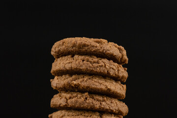 Delicious tasty snack of brown cookies with chocolate chip and peanut isolated on black background