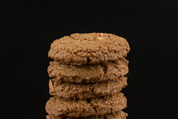 Delicious tasty snack of brown cookies with chocolate chip and peanut isolated on black background