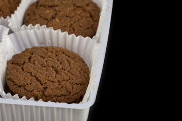 Delicious tasty snack of brown cookies with chocolate chip and peanut isolated on black background