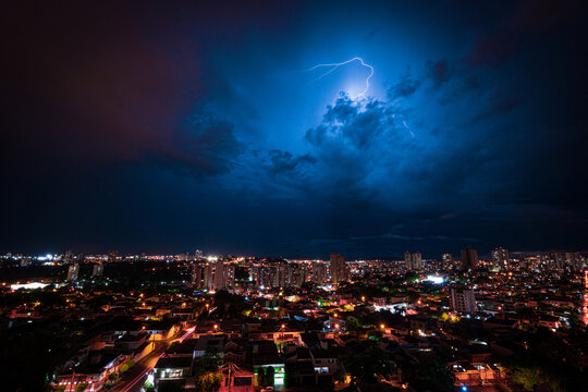 Lightning Storm Over Ribeirao Preto City in Brazil. Thunder blue light on a summer night concept image.