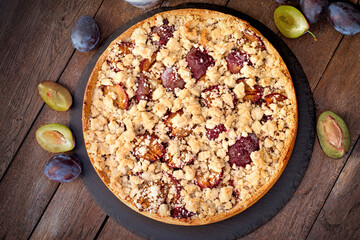 Sweet, delicious plum pie, homemade crumble cake with plum on table