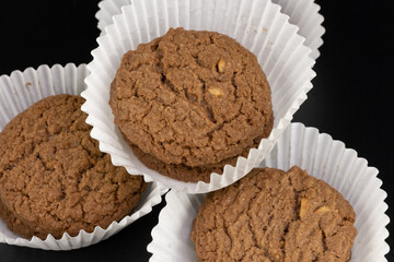 Delicious tasty snack of brown cookies with chocolate chip and peanut isolated on black background