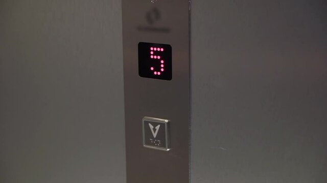 Elevator board on the floor. The lift goes up. Button with arrow and red display