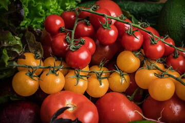 Yellow cherry tomatoes and other vegetables. Vegetarian still life. Fresh vegetables. Natural background.