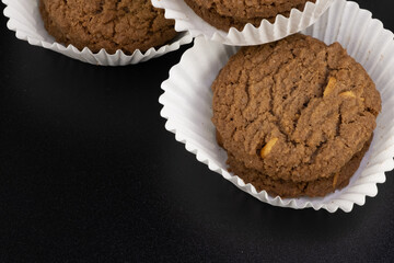 Delicious tasty snack of brown cookies with chocolate chip and peanut isolated on black background