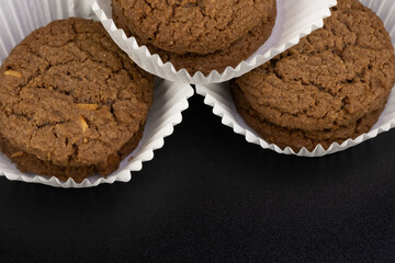 Delicious tasty snack of brown cookies with chocolate chip and peanut isolated on black background