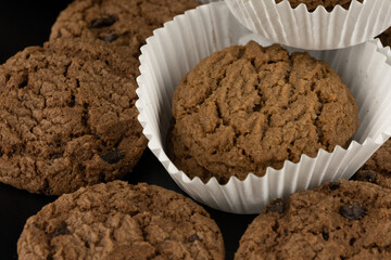 Delicious tasty snack of brown cookies with chocolate chip and peanut isolated on black background