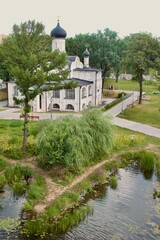 A church surrounded by greenery and a small reservoir in Moscow in Zaradie Park