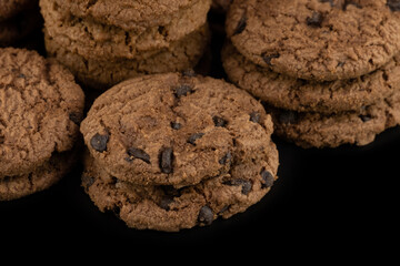 Delicious tasty snack of brown cookies with chocolate chip and peanut isolated on black background