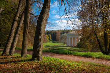 View of the Temple of Friendship on the bank of the Slavyanka River in the Pavlovsky Palace and Park Complex on an autumn sunny morning, St. Petersburg, Russia