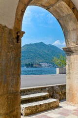 View of the serene bay through an ancient archway at Perast,near Kotor,Montenegro.