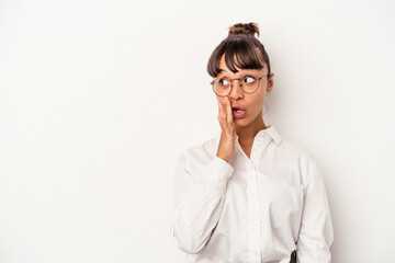 Young mixed race business woman isolated on white background  is saying a secret hot braking news...