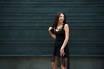 Smiling woman in slim black dress