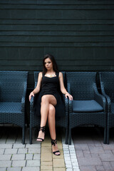 Smiling woman in slim black dress