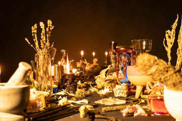 Witchy table arranged with witch craft magic items. Selective focus. Still life with black magic...