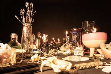 Witchy table arranged with witch craft magic items. Selective focus. Still life with black magic...