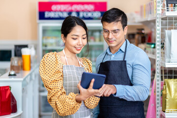 Business owner. A cheerful successful small business owner standing with his arms crossed smiles