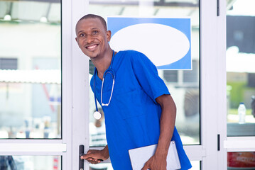 young male doctor holding digital tablet smiling