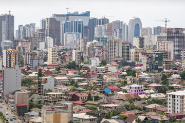 ariel panoramic view of old city and skyscrapers with the sea from the mountains