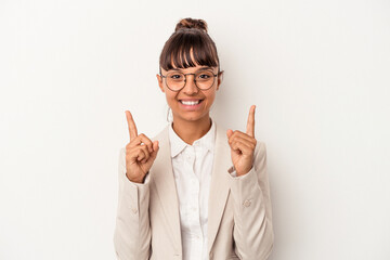 Young mixed race woman isolated on white background  indicates with both fore fingers up showing a...