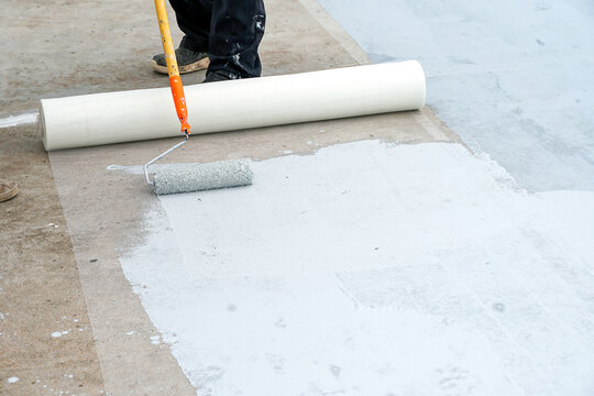 Hand painted gray flooring with paint rollers for waterproof, reinforcing net,Repairing waterproofing deck flooring.	