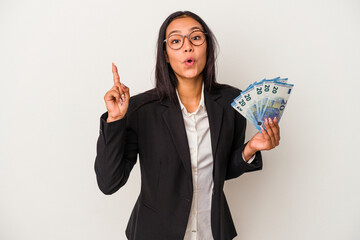 Young business latin woman holding bills coffee isolated on white background  having an idea, inspiration concept.