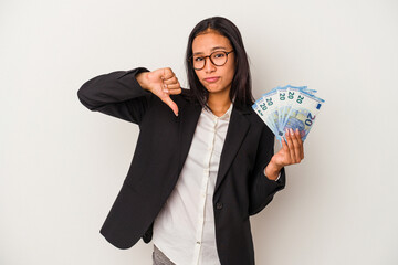 Young business latin woman holding bills coffee isolated on white background  showing a dislike...